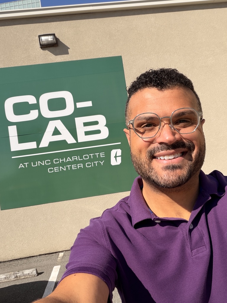Tyler outside the Co-Lab at UNC Charlotte Center City sign